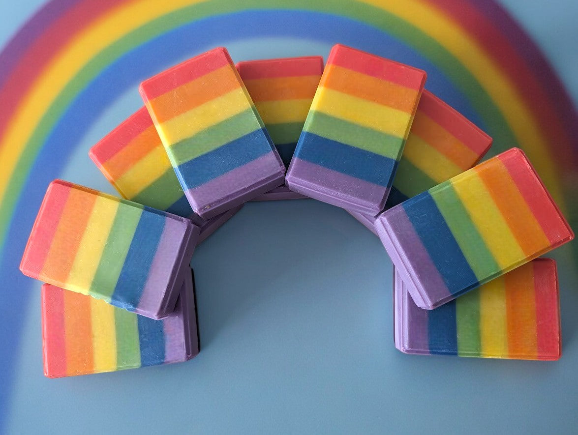 Artisan Bar Soap layer with vibrant rainbow / Pride flag colors. Bold, fluffy lather, it's a great addition to your personal care routine. It's personal meaning varies, but the message remains: love is love. Scented with a fresh, clean that evokes the freshness of laundry sun-dried and breeze kissed on a warm summer day!