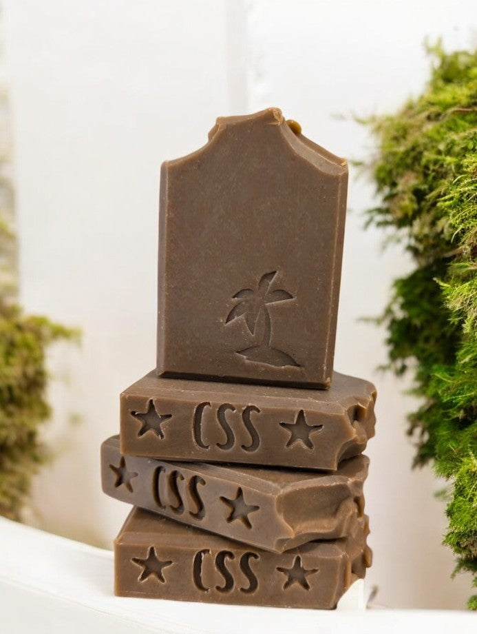 Artisan dark green soap with a palm tree stamped on the front of this harmonious, soap boasting the earthy fragrance of Patchouli with Hemp Oil and Kaolin Clay. It features a refined, understated Patchouli aroma, far from the overwhelming scent that may evoke memories of one's youth.