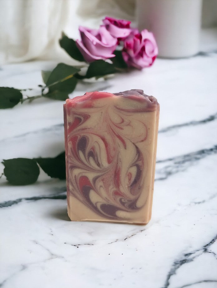 Creamy white handcrafted soap with delicate swirls of pink and purple. Top adorned with pink and purple swirls. Great for your personal care routine. Featuring Coconut Milk, colloidal oats and kaolin clay. Available in 3 sizes: regular bar, small bar and Travel / Guest / Hotel sized bars.