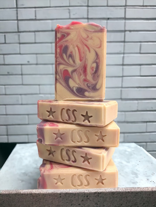 Creamy white handmade soap with delicate swirls of pink and purple.  Top adorned with pink and purple swirls.  Great for skin and your personal care routine.  Featuring Coconut Milk, colloidal oats and kaolin clay. Available in 3 sizes:  regular bar, small bar and Travel / Guest / Hotel sized bars.
