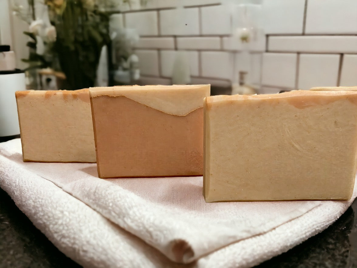 Travel or guest size soap, cold process soap featuring tangerine and tan block coloring separated by a gold mica line.  The scent is a refreshing blend of tangy citrus fruits (lemon, lime, grapefruit) paired with subtle notes of cucumber, pineapple, blackberry, and champagne. Think Burst of Energy* and you'll understand the scent. Also available in regular size, and small sizes.