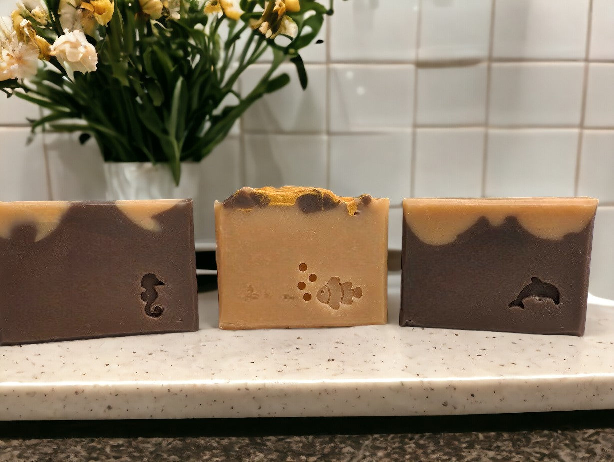 Two-toned artisan soap with dark brown on the bottom and lighter brown on top. Top adorned with brown and gold swirls. Great for your bath and beauty routine. Featuring Goat Milk, colloidal oats and kaolin clay. Available in 3 sizes: regular bar, small bar and Travel / Guest / Hotel sized bars.