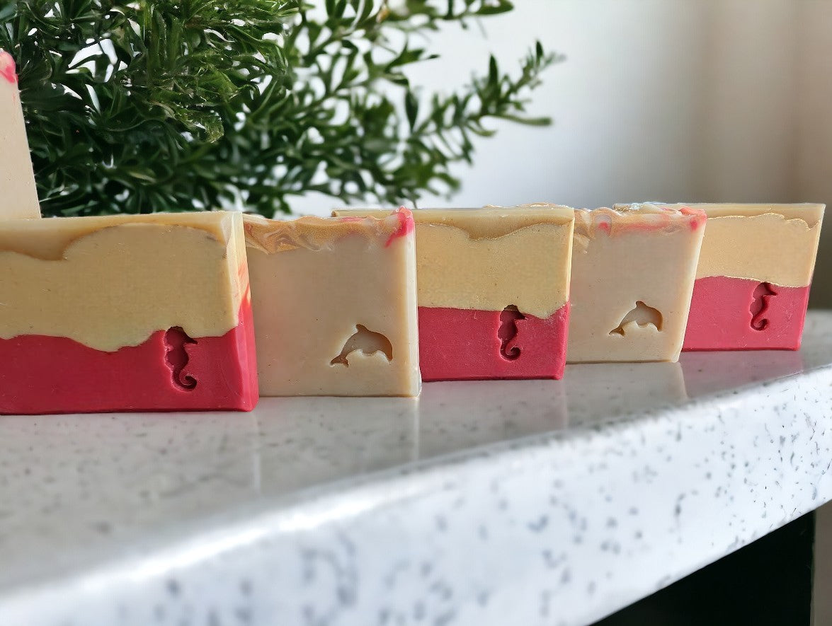 Cheryl's Southern Soapery Strawberry Peach Bellini soap bar featuring Avocado Oil and Goat milk soap. 3 layers of Red, peach and cream separate by gold lines. Topped with Red, peach and gold swirls. Fragranced with a Strawberry peach champagne to up your shower game. Available in 3 sizes: Regular soap bar size, Small bar and Travel/Guest or Hotel soap size.