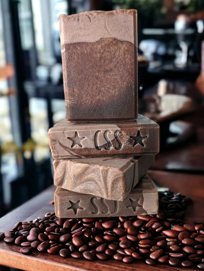 Coffee soap fragranced with Hot Chocolate. Top is a creamy light tan color with brown base that looks like aged leather on some bars. Goat milk, Colloidal oats and coffee are some of the special ingredients in this bubbly bar soap.