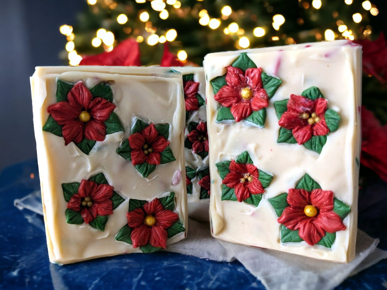 Take your holiday decor to the next level of festive with the Poinsettia Pizzazz Christmas soap! The soap is layered with Christmas green and off white with green, red and white soap sprinkles. The top of the soap is adorned with beautiful soap poinsettias. This decorative holiday soap will add a "ho-ho-hole lot" of fun and charm to your everyday routine during the holidays. Celebrate the season while you lather up and get squeaky clean!