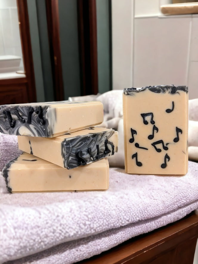 Fun skin lovin’ Tallow Bar Soap, cream background with black Musical Notes embedded throughout. Handcrafted in small batches with goat's milk and a light Bamboo and Teakwood scent along with other skin lovin' ingredients, it's sure to be a hit with music lovers!