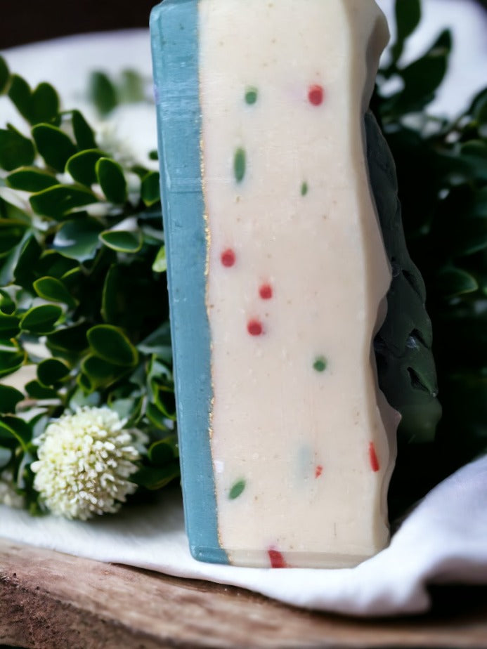 Take holiday decor the next level of festive with the Tannenbaum Tingle Holiday Soap! This is no ordinary bar of soap - the soap is topped with a Christmas Tree soap charm and with red and green sprinkles throughout. This decorative soap will add a "ho-ho-hole lot" of fun and charm to your everyday routine during the holidays. Celebrate the season while you lather up and get squeaky clean!