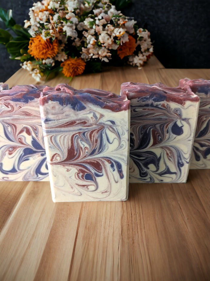 Handcrafted goat milk bar soap scented with Lavender essential oil.  Features purple and burgandy swirls against an off white background.  Creamy goat milk, and a combination of cocoa, shea, mango, and kokum butters, this soap is truly indulgent.
