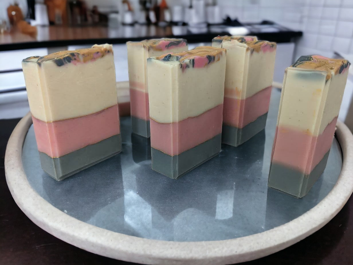 This beautiful handmade soap boasts Cocoa, Shea, Mango and Kokum butters and has layers of white, pink, and grey that are separated by elegant gold mica lines. Fragrance and essential oil blend (think Coco Mademoiselle*).  This soap will definitely up your skincare game.