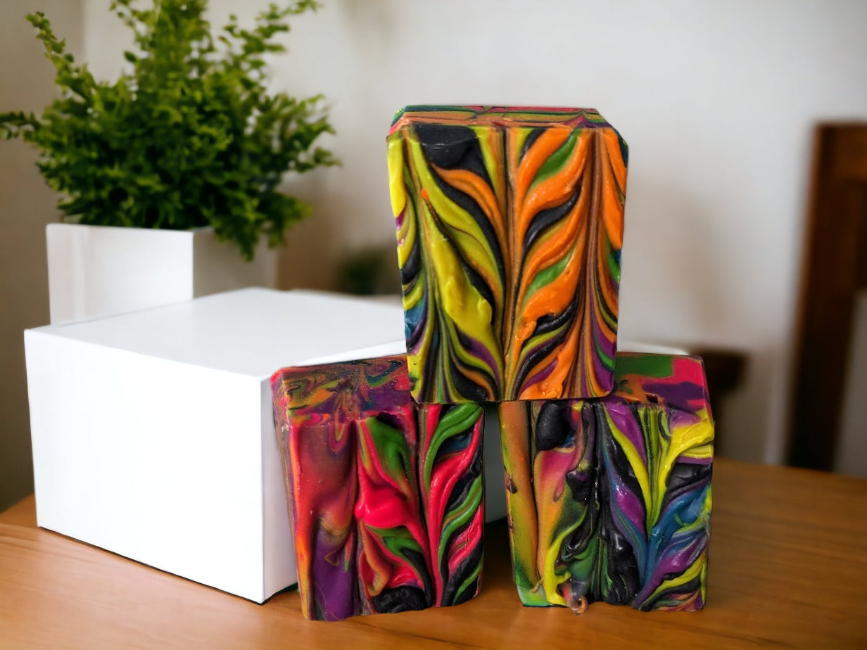 Our small batch neon soap bar is bright and bold, featuring eye-catching neon spin swirls of pink, blue, orange, green, yellow and purple throughout the bar. Handcrafted in small batches, Tussah Silk, Rice Bran and Avocado oils give this soap a wonderful and creamy texture. Uncover how the soap design changes as you use it.
