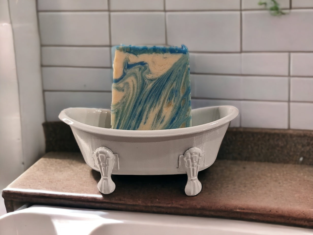 Self-draining, decorative soap holder in the shape of a vintage clawfoot bathtub. Metal with ceramic coating.