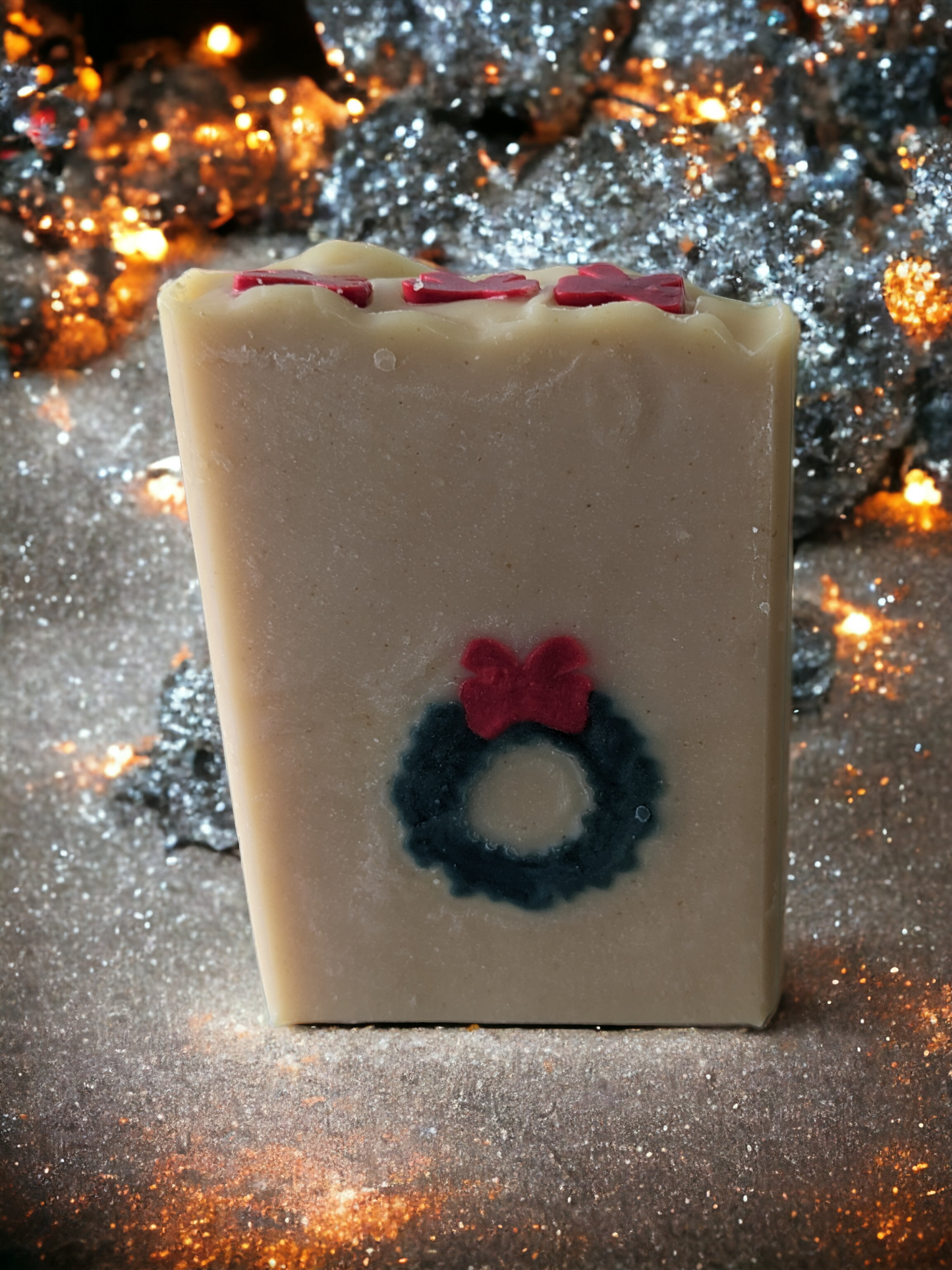 Delightful handmade, decorative Christmas soap bar. This bar features a green wreath and red ribbon that goes through the entire soap bar (from front to back)! Scented with Evergreen Forest fragrance oil, it's perfect for bringing that special festive something to any bathroom! So, ‘tis the season to be merry—get your Wreath of Green soap bar today!