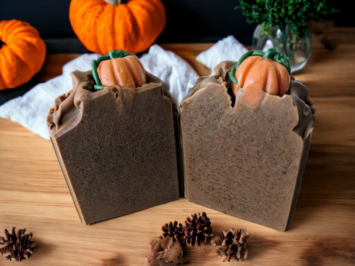 Tall soap bar with pumpkin soap embed on top, round with pumpkin on top and round with no pumpkin on top. Brown in color.