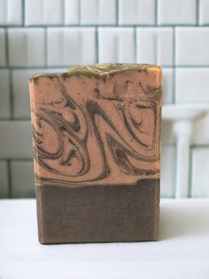 Bubbly soap bar with great lather! Features swirls of brown and green that'll have you dreaming of crisp air, a good read, a crackling fire, and your fave sweater! Embrace the cozy vibes of autumn and winter with this delightful bar!! Similar to BBW's Sweater Weather* scent.