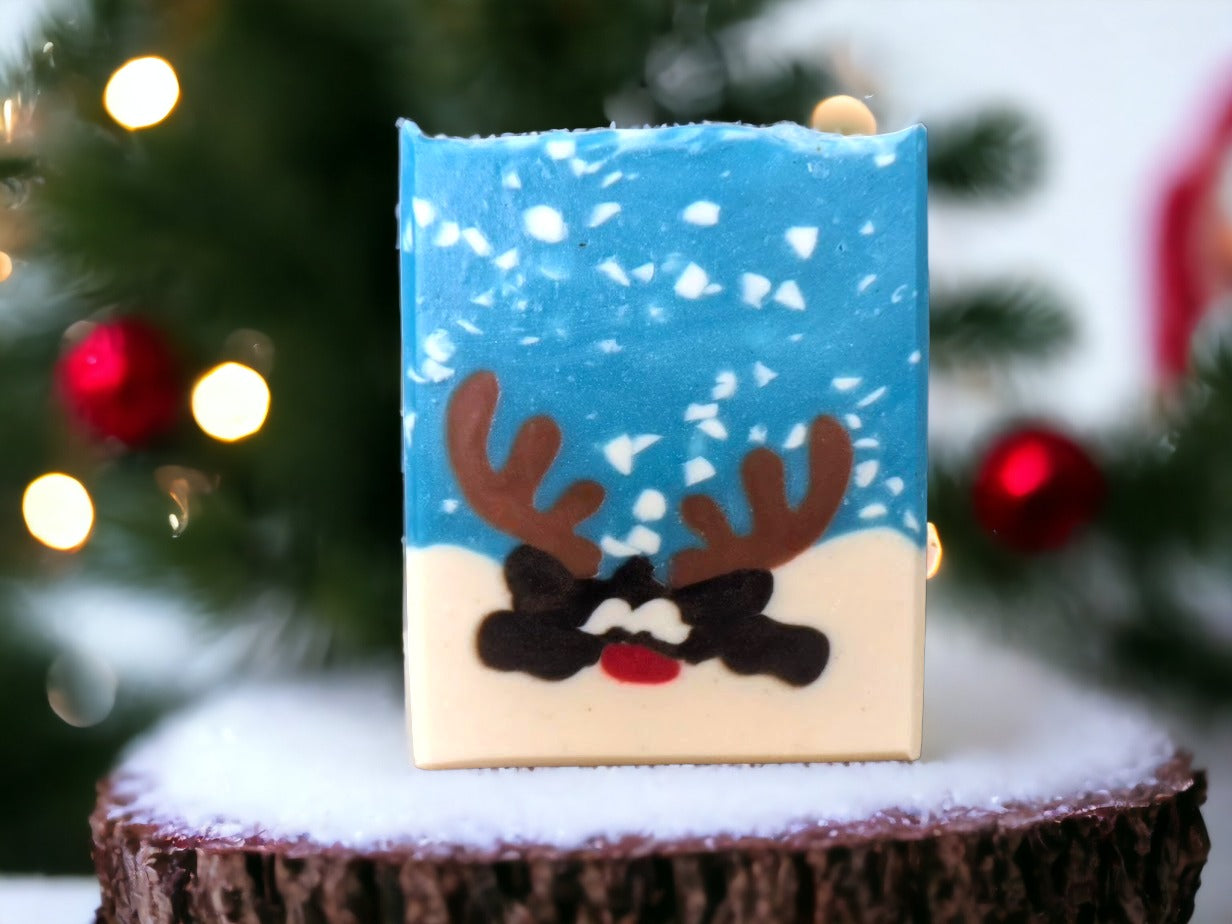 Delightful tallow holiday bar soap to add to your holiday decor. This cute soap with a reindeer peeking over a snowbank in a snowy scene is sure to delight your family and guests. Loaded up with skin loving ingredients and scented with 'Peppermint Stick', you're sure to get a holly jolly clean with this fun holiday soap bar!