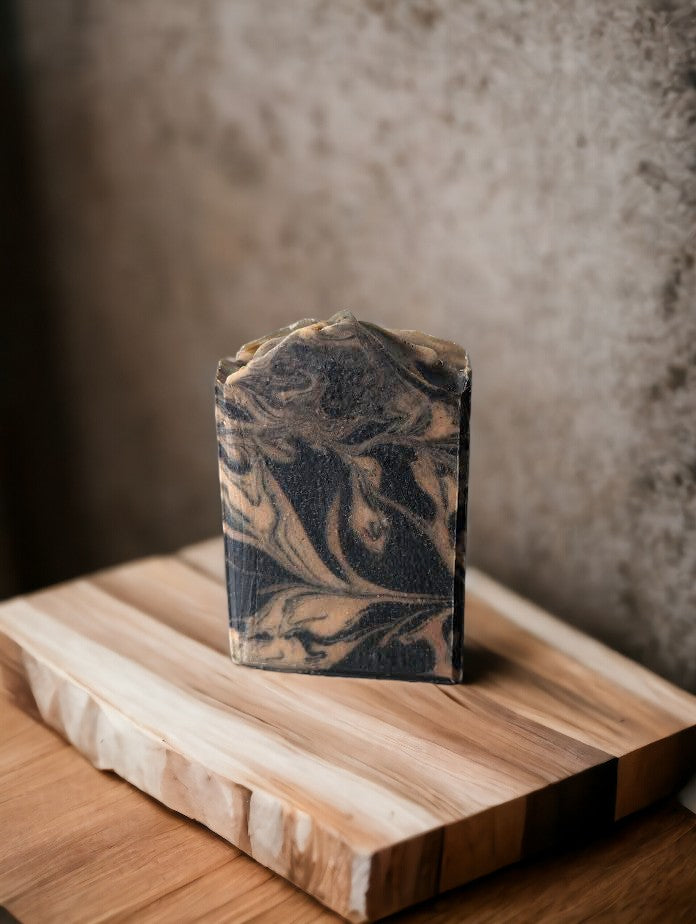 Artisan, handcrafted Black soap with gold swirls. Healthy and skin loving ingredients include Activated Charcoal, Kaolin Clay, Colloidal Oats and Coconut milk. Fragranced with Lavender and Black Amber Fragranced Bar Soap.