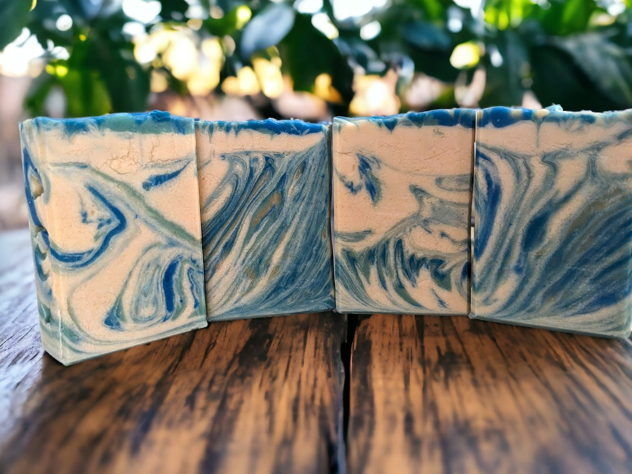 This small batch, decorative soap smells heavenly, and wows with its whimsical swirls of blue, creamy white and veins of gold. Every single bar of soap different in appearance. Reminiscent of an August sunset here in Florida, this beautiful soap has a fantastic sudsy lather -- bubbles galore!  The scent on this soap is divine!!  Think Amazing Grace* by Philosopy and you'll get it.  Notes of Bergamot, lemon, citron and neroli, jasmine, orange blossom and rose with touch of musk and cedarwood.