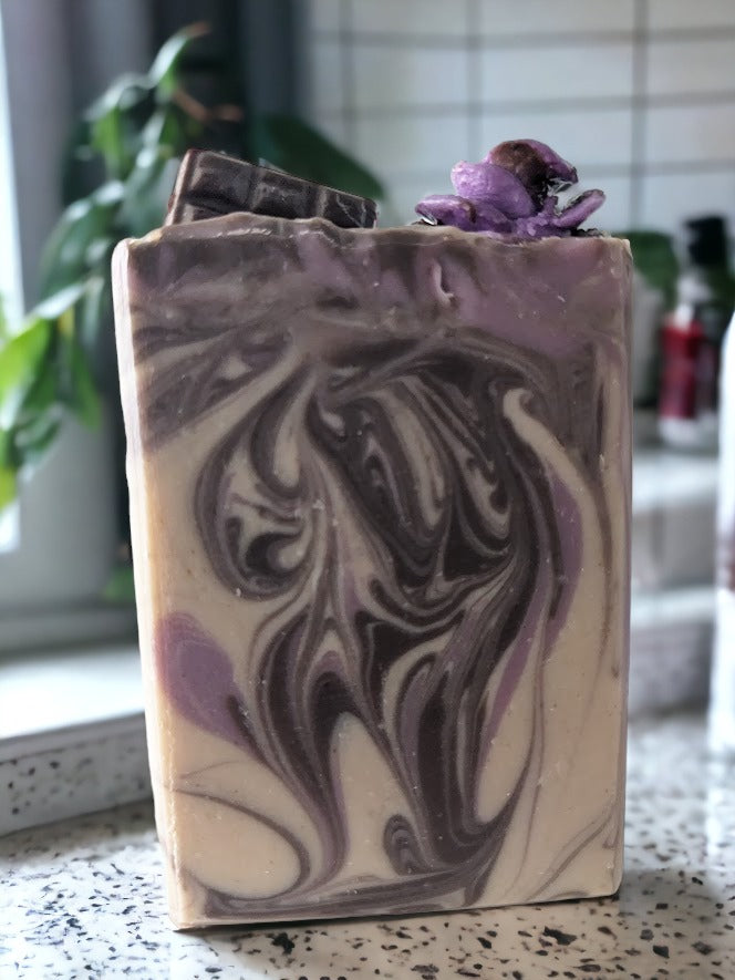 Small batch chocolate-lavender butter soap bar! Handcrafted design elements that include divine whispy swirls in chocoloate brown and lavender, and topped with chocolate lavender soap roses, your skin will feel as smooth as the butters it's created with.  Scented with a divine chocolate and lavender fragrance!  This butter bar is a must buy, must try!