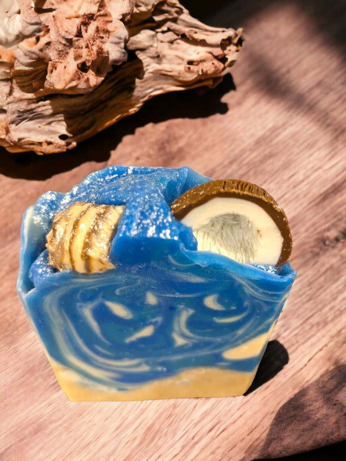 Fun beach-themed soap bar.  Handcrafted with all-natural, nourishing butters like shea, cocoa, mango and kokum. The fun soapy decorations include a half coconut and realistic sea shells and bright colors that will transport you right to the Caribbean, no matter where you are! Enjoy a luxurious, 'Coconut Paradise' fragrant lather each time you wash, and get ready to treasure the summer vibes all year round.