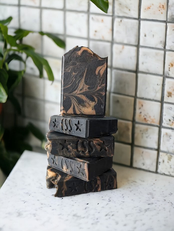 Black soap with delicate gold swirls.  Bubbly lather and Activated Charcoal, Kaolin Clay, Colloidal Oats and Coconut contribute to this bubbly Lavender and Black Amber Fragranced Bar Soap.