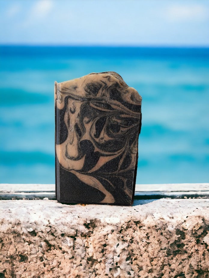 Black soap with gold swirls. Healthy and skin loving ingredients include Activated Charcoal, Kaolin Clay, Colloidal Oats and Coconut milk. Fragranced with Lavender and Black Amber Fragranced Bar Soap.