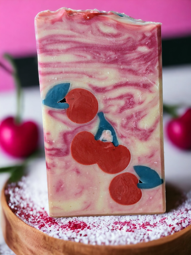 Delightful creamy bar soap featuring cherry soap embeds, light black cherry scent and a gentle red and cream swirled background. Creamy lather and lots of suds, this soap is sure to please!