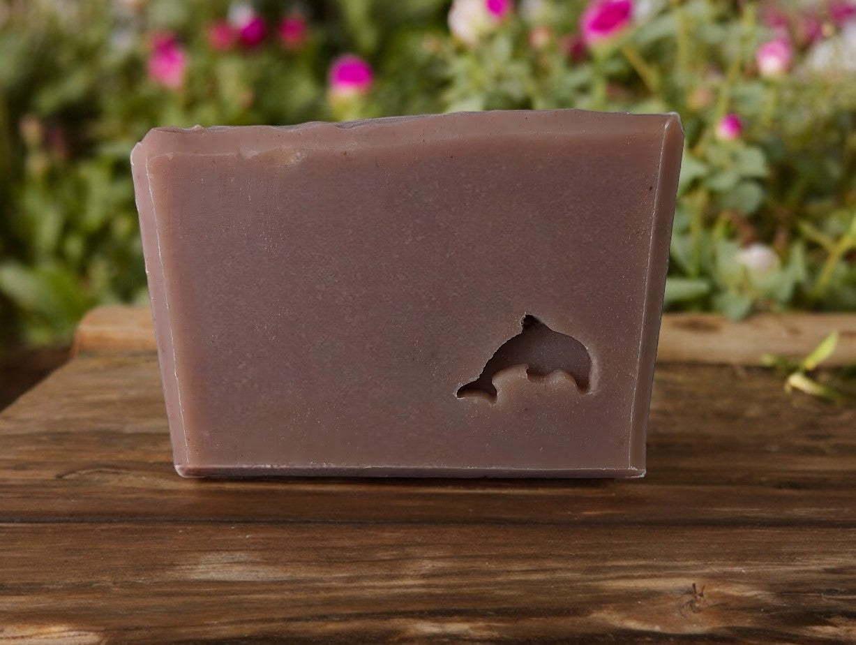 Plum colored handcrafted soap with a dolphin stamped into the front. Features goat milk, sea moss and the usual cast of Kaolin Clay, colloidal oats and soap nuts, this one is the a must add to your bath and body products. It's a formidable bar with a fragrance to match its strength. It has a crazy bubbly lather too!! This Baccarat Rouge 540* to understand essence of the scent.