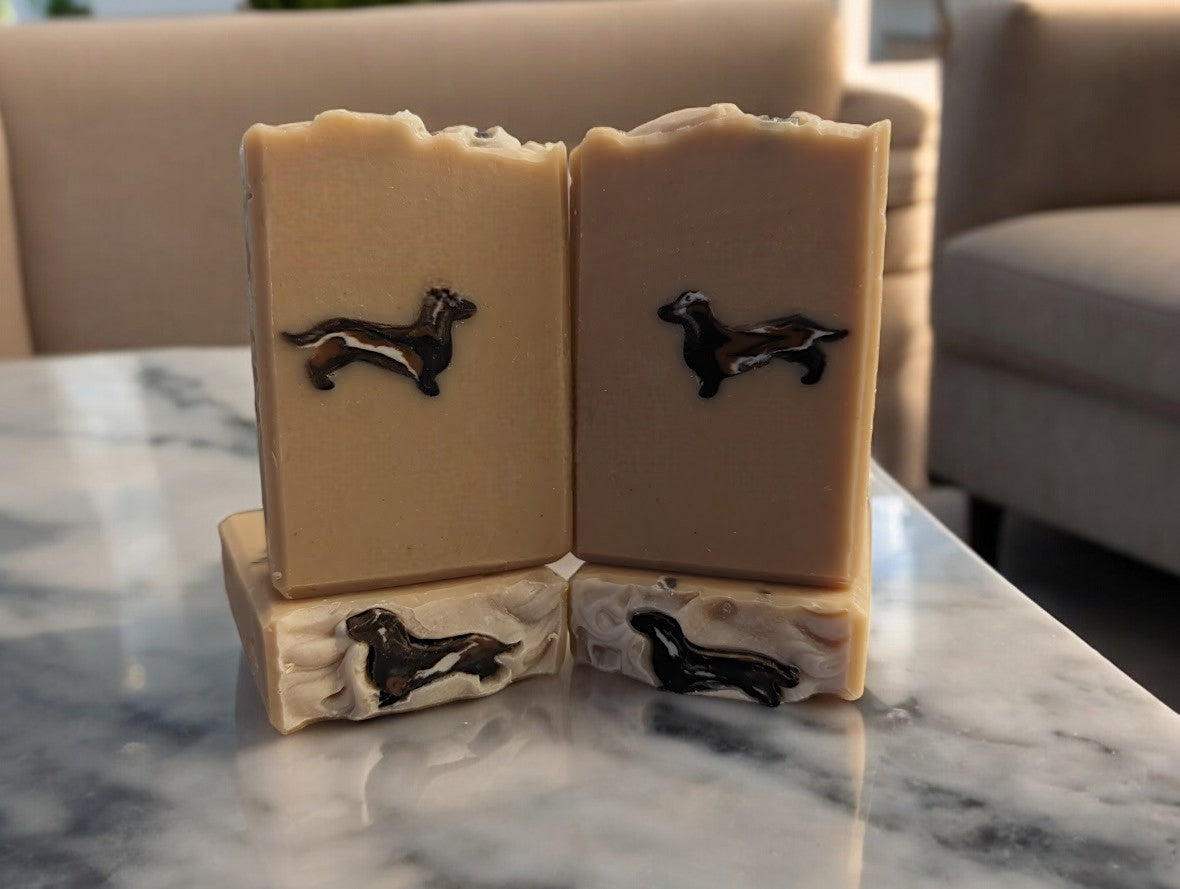 Attention Dachshund lovers!! Beige colored soap bar featuring a dapple dachshund dog soap embed.  Handcrafted with skin loving ingredients like Kaolin Clay, Colloidal Oats and Goat Milk, this is the perfect addition to your personal care routine or a perfect gift for the doxie lover in your life.