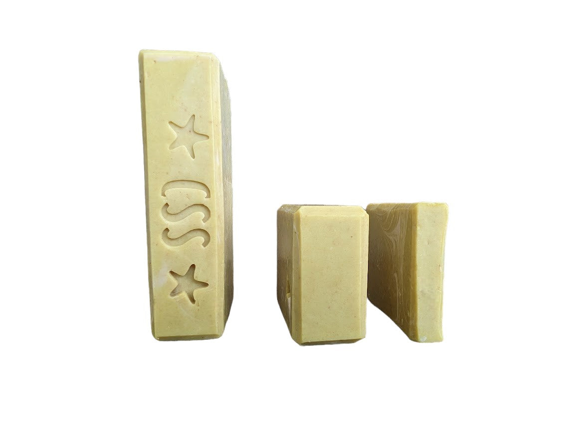 Handcrafted, cold process Banana Breeze Bar (aka Monkey Farts) Goat Milk Soap to up your skin care game.  Mustard colored base with white swirls. Available in 3 sizes Regular bar, small bar and Travel Guest Hotel sized soap bar. Available from Cheryl's Southern Soapery.