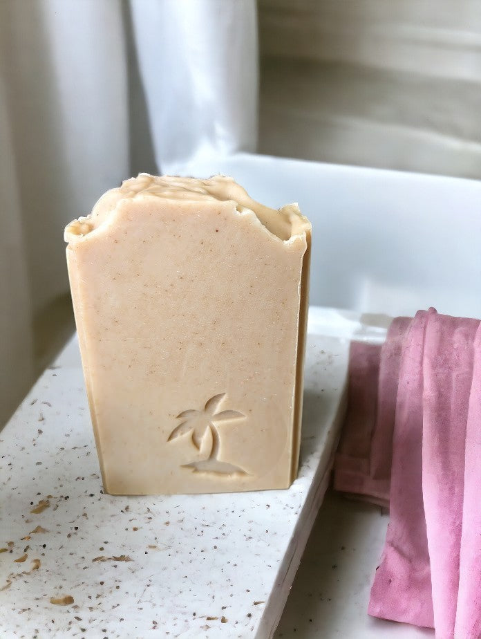 Smokey Beige colored, nourishing, bath and body soap with Palm Tree, paw print, dolphin clown fish or sea horse embellishments. Features goat milk, kaolin clay, colloidal oats, & other skin loving ingredients, this skin loving soap is topped off with the divine Palo Santo fragrance oil. Comes in 3 sizes:  Regular bar, Small Bar and Travel / Guest size bar 