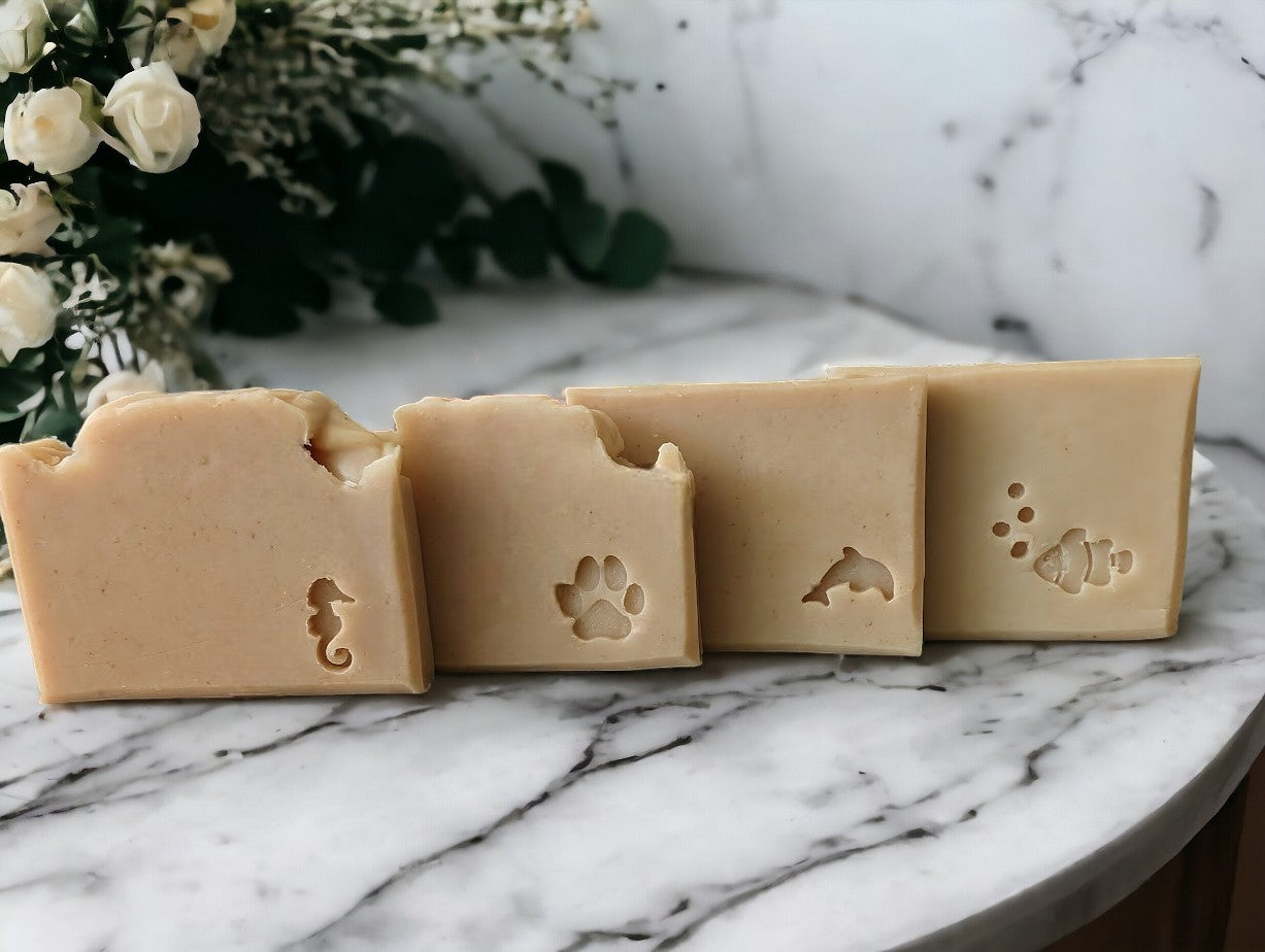 Smokey Beige colored, nourishing skin care soap with stamped embellishments. Features goat milk, kaolin clay, colloidal oats, & other skin loving ingredients, this skin loving soap is topped off with the divine Palo Santo fragrance oil. Comes in 3 sizes:  Regular bar, Small Bar and Travel / Guest size bar 