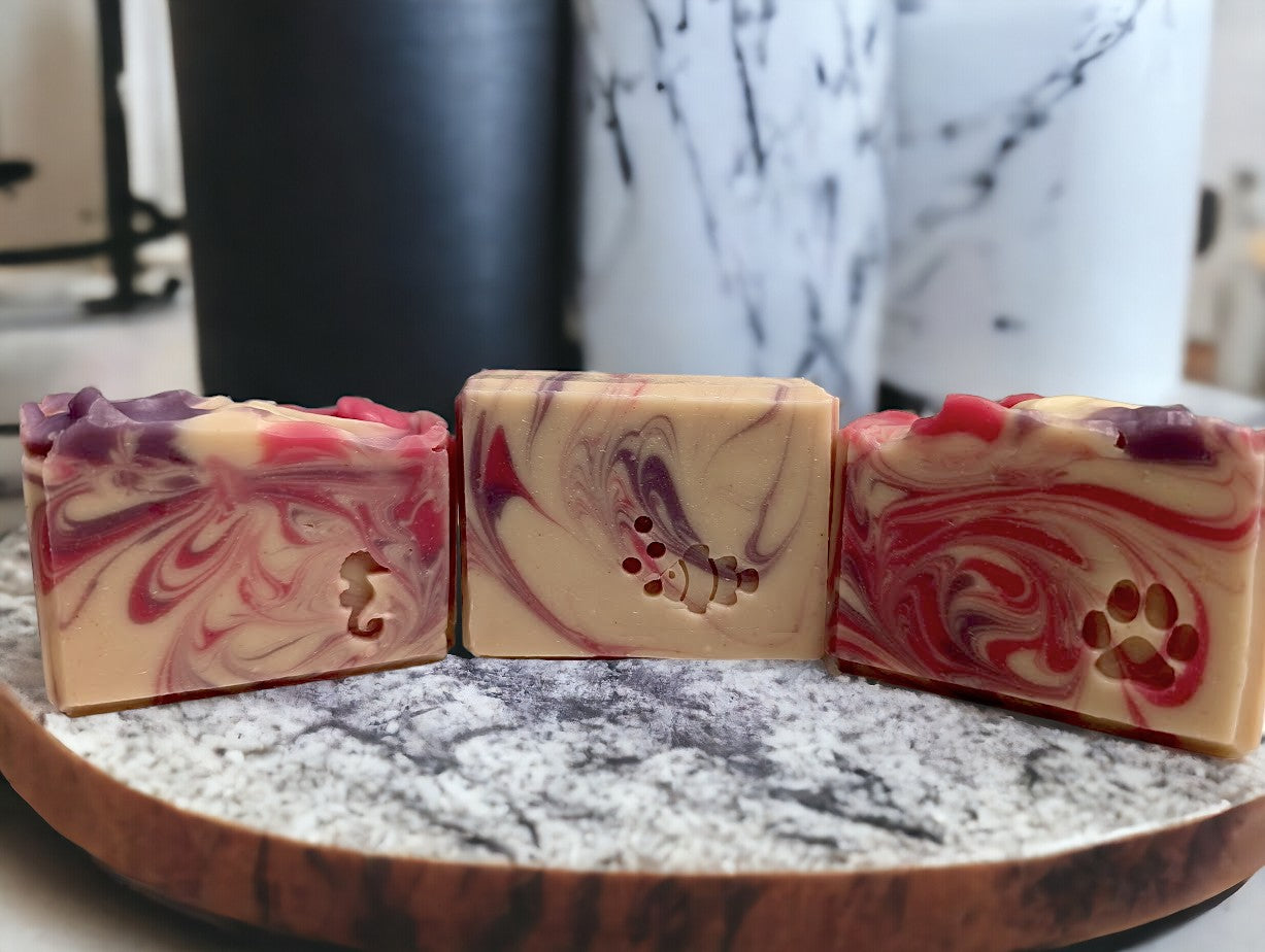 Creamy white handmade soap with delicate swirls of pink and purple.  Top adorned with pink and purple swirls.  Good Soap and great for skin care.  Featuring Coconut Milk, colloidal oats and kaolin clay. Available in 3 sizes:  regular bar, small bar and Travel / Guest / Hotel sized bars.