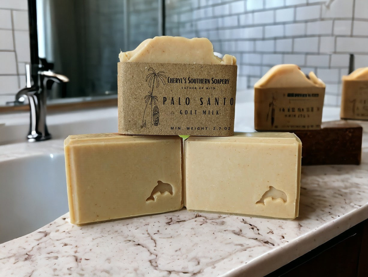 Handmade, smokey Beige colored, nourishing, personal care soap with stamped embellishments. Features goat milk, kaolin clay, colloidal oats, & other skin loving ingredients, this skin loving soap is topped off with the divine Palo Santo fragrance oil. Comes in 3 sizes:  Regular bar, Small Bar and Travel / Guest size bar 