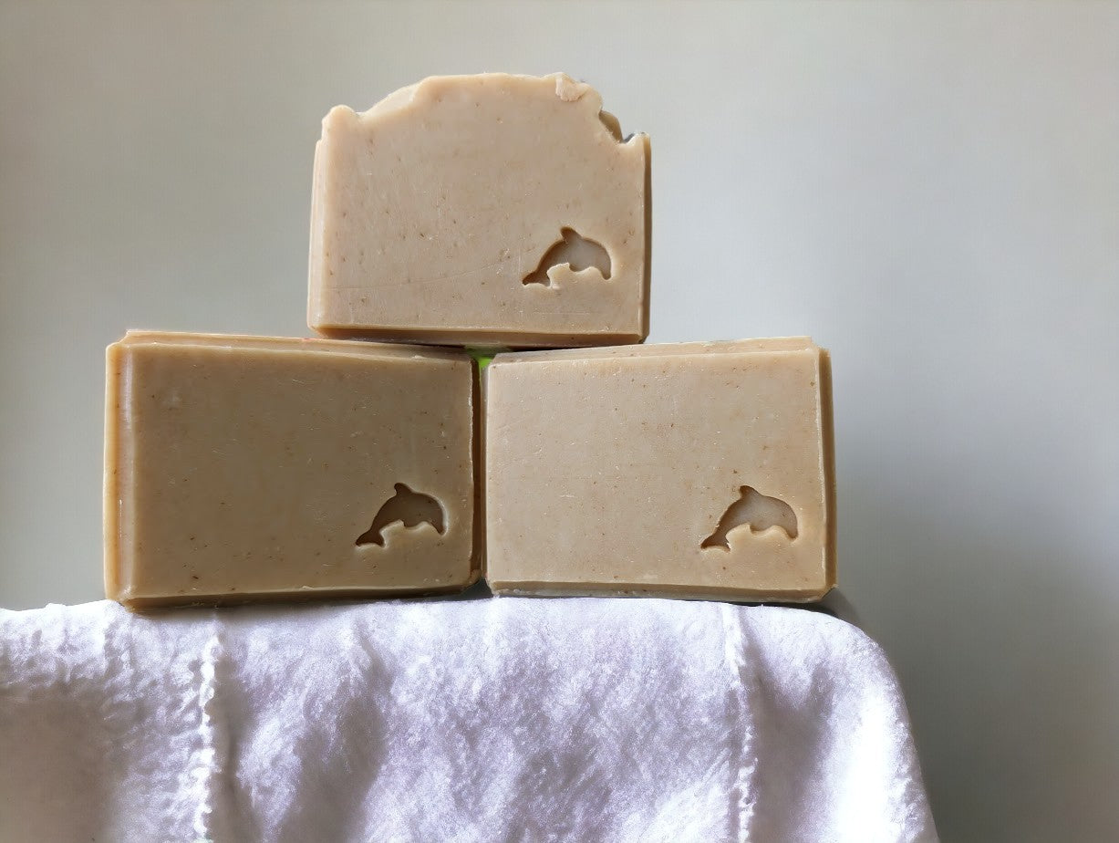 Smokey Beige colored, nourishing, personal care soap with stamped embellishments. Features goat milk, kaolin clay, colloidal oats, & other skin loving ingredients, this skin loving soap is topped off with the divine Palo Santo fragrance oil. Comes in 3 sizes:  Regular bar, Small Bar and Travel / Guest size bar 