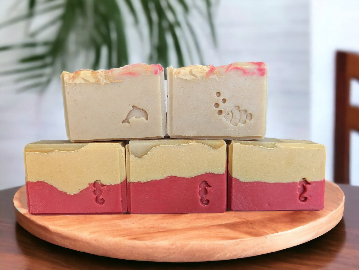 Beautiful handcrafted cold process Avocado Oil and Goat milk soap.  3 layers of Red, peach and cream separate by gold lines.  Red, peach and gold swirls adorn the top of the soap.  Fragranced with a  Strawberry peach champagne to up bath routine game.  Available in 3 sizes:  Regular soap bar size, Small bar and Travel/Guest or Hotel soap size.