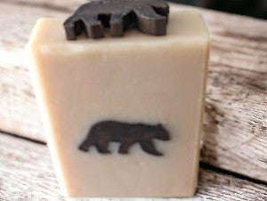 This handcrafted soap from Cheryl's Southern Soapery  boasts a delightful dark brown bear-shaped embed on a light tan base. This is a perfect for Dad or the special man in your life. Formulated with luxurious goat milk & tallow, it's a treasure trove of nourishing ingredients such as Kaolin Clay & Colloidal Oats. Bump up your skin care routine & lather up with this gentle bar. Your skin will feel 'bear-y' pampered.