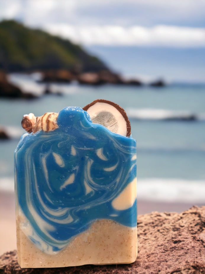 Fun beach-themed soap bar.  Handcrafted with all-natural, nourishing butters like shea, cocoa, mango and kokum. The top is decorated with a half coconut and realistic sea shells (all soap of course!).  It's bright colors that will transport you right to the Caribbean, no matter where you are! Enjoy a luxurious, 'Coconut Paradise' fragrant lather each time you wash, and get ready to treasure the summer vibes all year round.