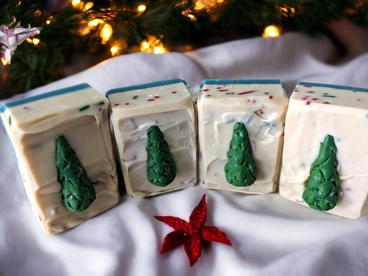 Take your bath time to the next level of festive with the Tannenbaum Tingle Holiday Soap! This is no ordinary bar of soap - the soap is topped with a  Christmas Tree soap charm and with red and green sprinkles throughout.  This decorative soap will add a "ho-ho-hole lot" of fun and charm to your everyday routine during the holidays. Celebrate the season while you lather up and get squeaky clean!