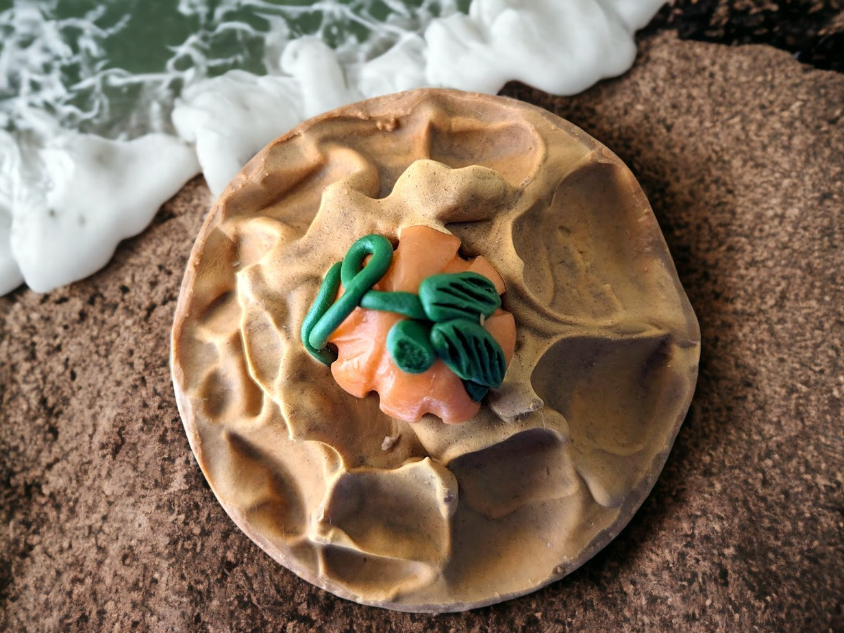 Round soap bar with soap pumpkin embed on top.