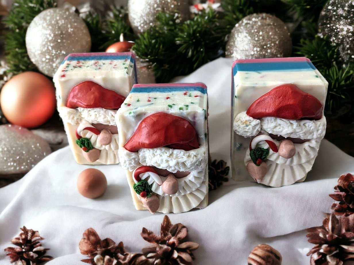 Soap with a Santa Claus head on top.  Santa is holding a candy cane.  Body of the soap is layered starting with red, then green and a creamy white with red and green soap sprinkles.