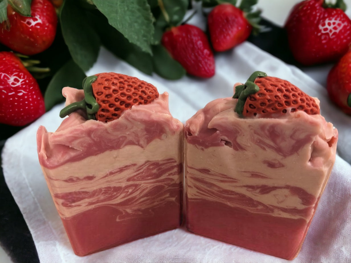 Enjoy the scent fresh picked strawberries with our luxurious Butter Soap Bar! This delightful 4 butter strawberry bar will make you feel like you're right in the middle of a strawberry patch. Topped with a soap strawberrry and a body of red and cream swirls, this handcrafted soap bar is loaded with skin lovin' ingredients, your skin will feel refreshed with a soft silky finish.