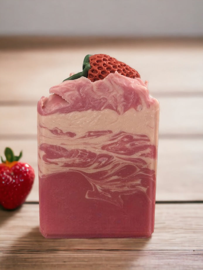 Enjoy the scent fresh picked strawberries with our luxurious Butter Soap Bar! This delightful 4 butter strawberry bar will make you feel like you're right in the middle of a strawberry patch. Topped with a soap strawberrry and a body of red and cream swirls, this handcrafted soap bar is loaded with skin lovin' ingredients, your skin will feel refreshed with a soft silky finish.