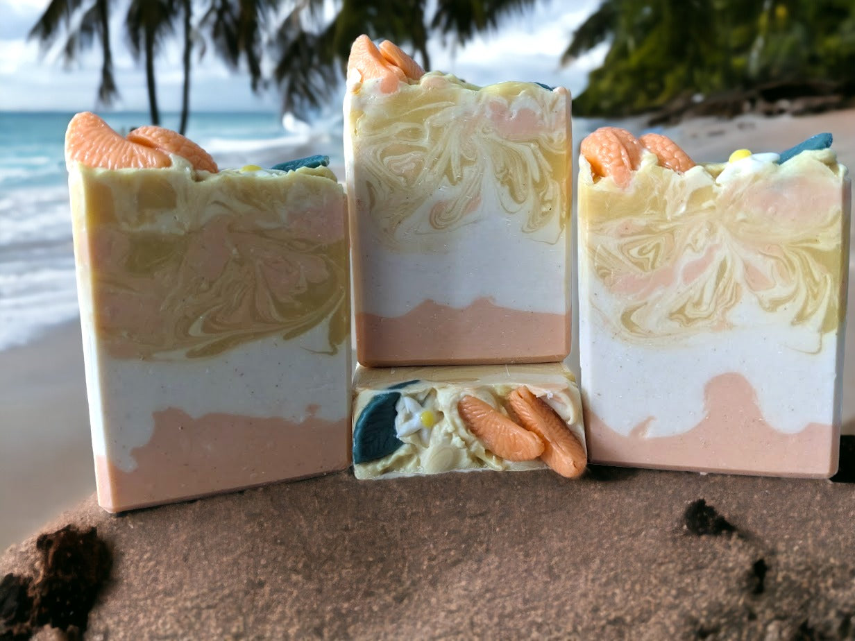 Take a dreamy shower with Tangerine Dream Soap! This soap is topped with tangerine wedges, a small white tree bud and leaf.  The body of the soap has 3 layers:  bottom and middle:  solid tangerine and white layers and the top layer has swirls of white, tangerine and yellow.  This handcrafted soap will leave you feeling refreshed and revitalized. Our unique blend of luxury oils and butters is sure to make you "peel" good!