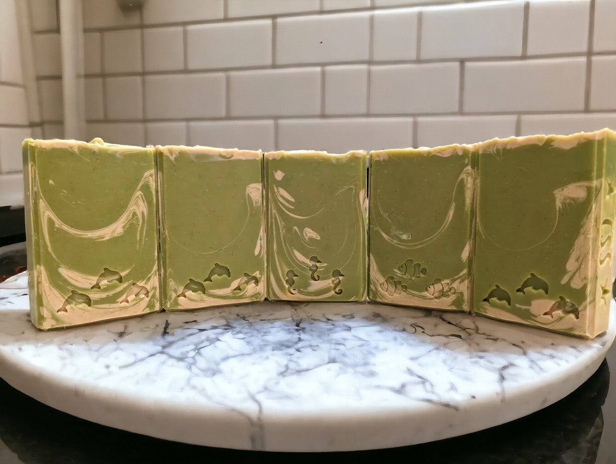 Lime green regular sized soap with cream swirl accents. Scented with Key Lime Pie fragrance oil.  Each stamp is stamped with dolphins, sea horses or clown fish.  Soap features Hemp Oil, Shea Butter, Goat Milk, Kaolin clay and colloidal oats. 