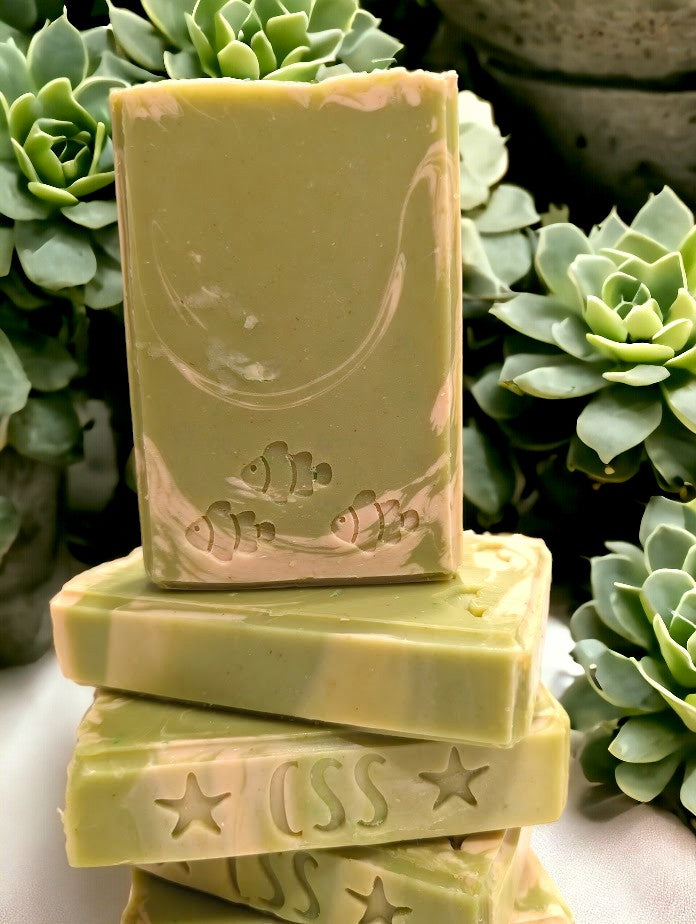 Lime green regular sized soap with cream swirl accents. Scented with Key Lime Pie fragrance oil.  Each stamp is stamped with dolphins, sea horses or clown fish.  Soap features Hemp Oil, Shea Butter, Goat Milk, Kaolin clay and colloidal oats. 