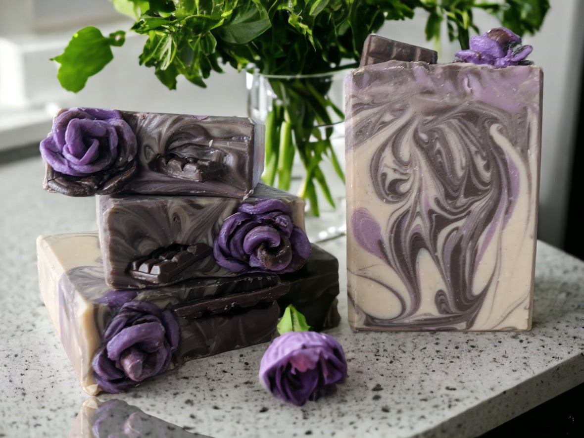 Up your shower and bath game with this artisan chocolate-lavender butter soap bar! Handcrafted design elements that include divine whispy swirls in chocoloate brown and lavender, and topped with chocolate lavender soap roses, your skin will feel as smooth as the butters it's created with.  Scented with a divine chocolate and lavender fragrance!  This delectable, skin lovin’ butter bar is a must buy, must try!