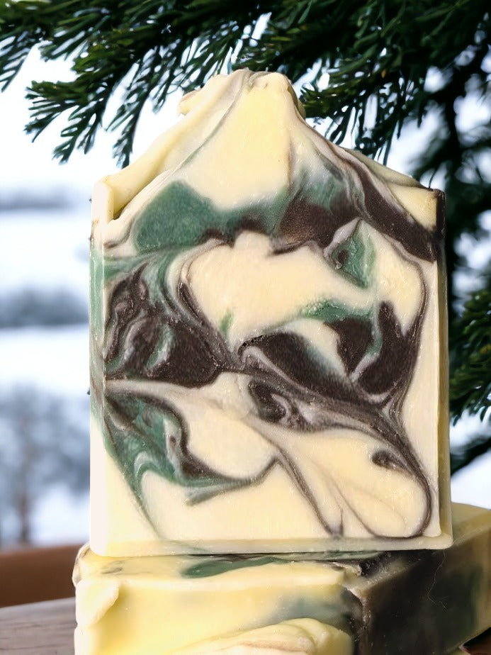 Forest Fresh - Camouflage luxury butter bar with Pine Scent! Take a walk in the woods and the crisp winter air with the soothing scent of evergreen trees.  Enjoy the delightful brown and green swirl design on a cream background, mild exfoliation of the Kaolin clay for a unique, luxurious and refreshing experience. Treat yo' self!