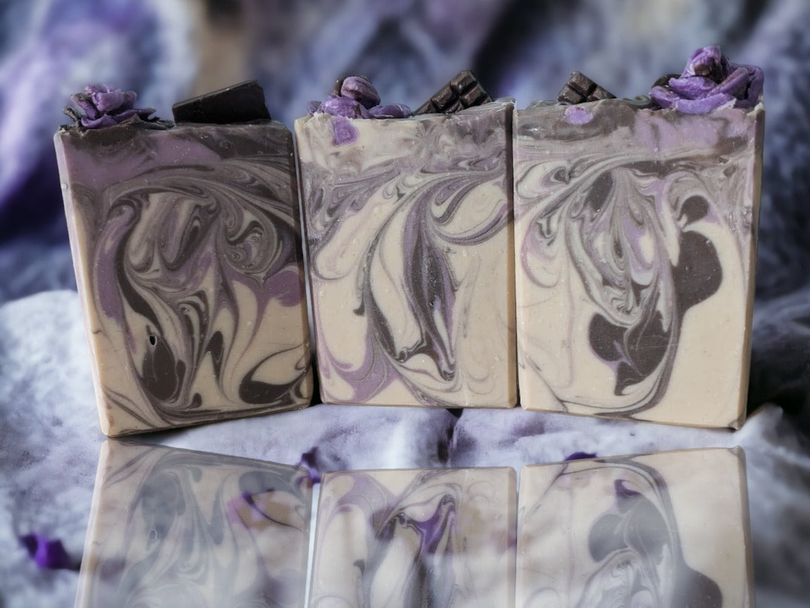 Artisan chocolate-lavender butter soap bar! Handcrafted design elements that include divine whispy swirls in chocoloate brown and lavender, and topped with chocolate lavender soap roses, your skin will feel as smooth as the butters it's created with.  Scented with a divine chocolate and lavender fragrance!  This butter bar is a must buy, must try!