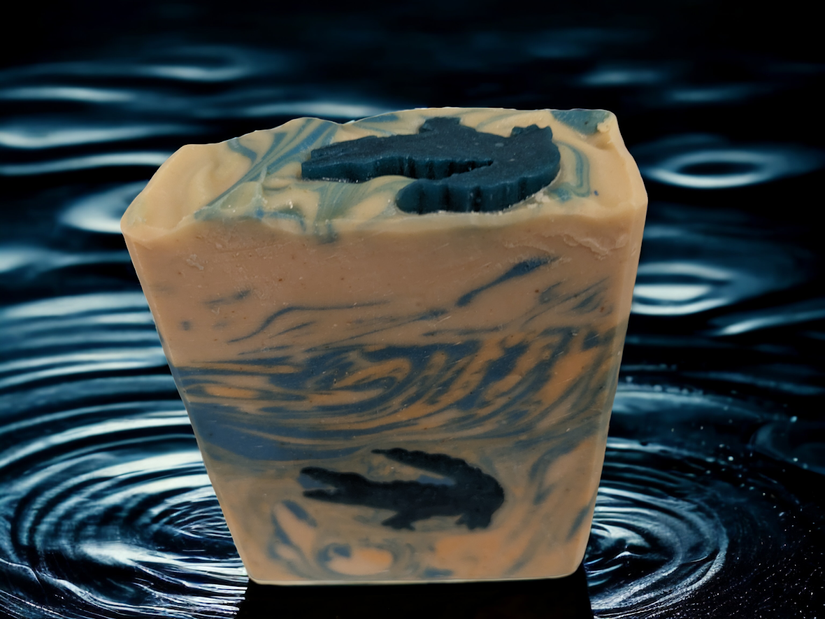 Ready for adventure? Let your imagination run wild with our unique, Fun Alligator Tallow Bar Soap. The top of this skin lovin soap features an alligator and the body has soapy alligator embeds with blue and orange swirly water throughout the soap.  Handcrafted in small batches and a hint of Kentucky Bourbon scent it’s got a creamy and sudsy lather that will leave you feelin' refreshed all day and ready to take on whatever the wild throws at you.