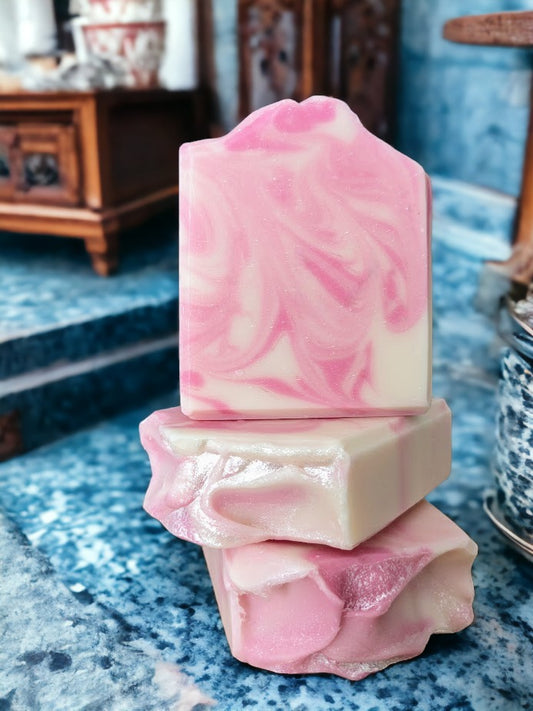 Marvel at the sophisticated swirly design of this Pink and white Rose Quartz bar soap! You'll discover a luscious lather made with Green Tea Seed Oil and Tussah Silk and skin loving oils. Whether you prefer scented with Rose Quartz Fragrance Oil.  Dive into a soapy oasis of delight!